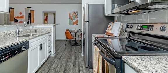 a kitchen with stainless steel appliances and white cabinets