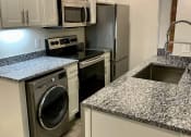 Thumbnail 8 of 20 - Kitchen with Stainless Steel Appliances and Granite Countertops, San Sofia Apartments, Cleveland, OH, 44113