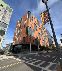 a rendering of a large building on a city street