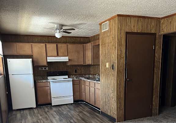 a dining room and kitchen with a table and chairs