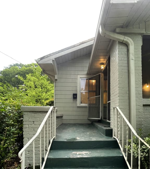 a view of the front of a house with stairs and a porch