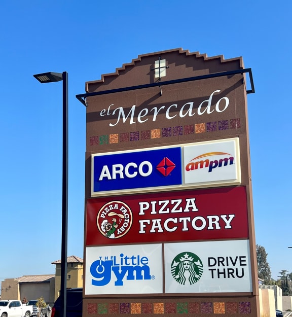 a sign for a restaurant with various logos on it