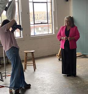 a man taking a picture of a woman in a room