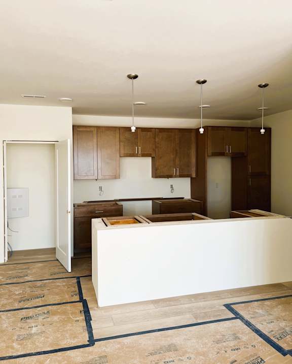 A kitchen with brown cabinets and a white island.