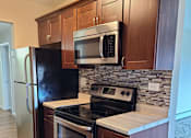 Thumbnail 13 of 48 - Rehabbed kitchen with cherry  cabinets and glass backsplash
