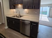 Thumbnail 6 of 48 - Rehabbed kitchen with slate grey cabinets and glass backsplash