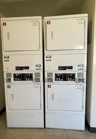 Two identical washing machines are stacked on top of each other.