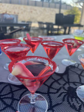 a bunch of red martinis on a table