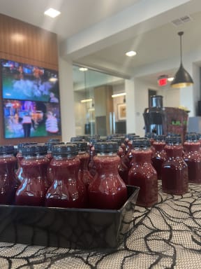 bottles of ketchup on a table in front of a tv