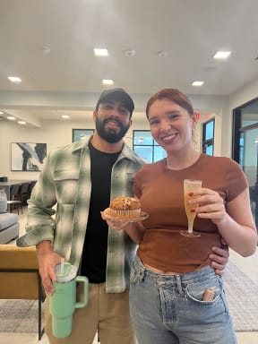 a man and a woman holding drinks and a cupcake