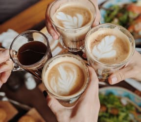 a group of people holding up three glasses of coffee at La Terraza, Phoenix, AZ, 85018