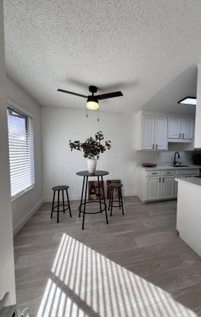 a white kitchen with wood floors and white cabinets at Campbell West, Campbell, CA
