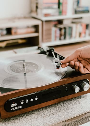 a person cutting a record on a technologic turntable
