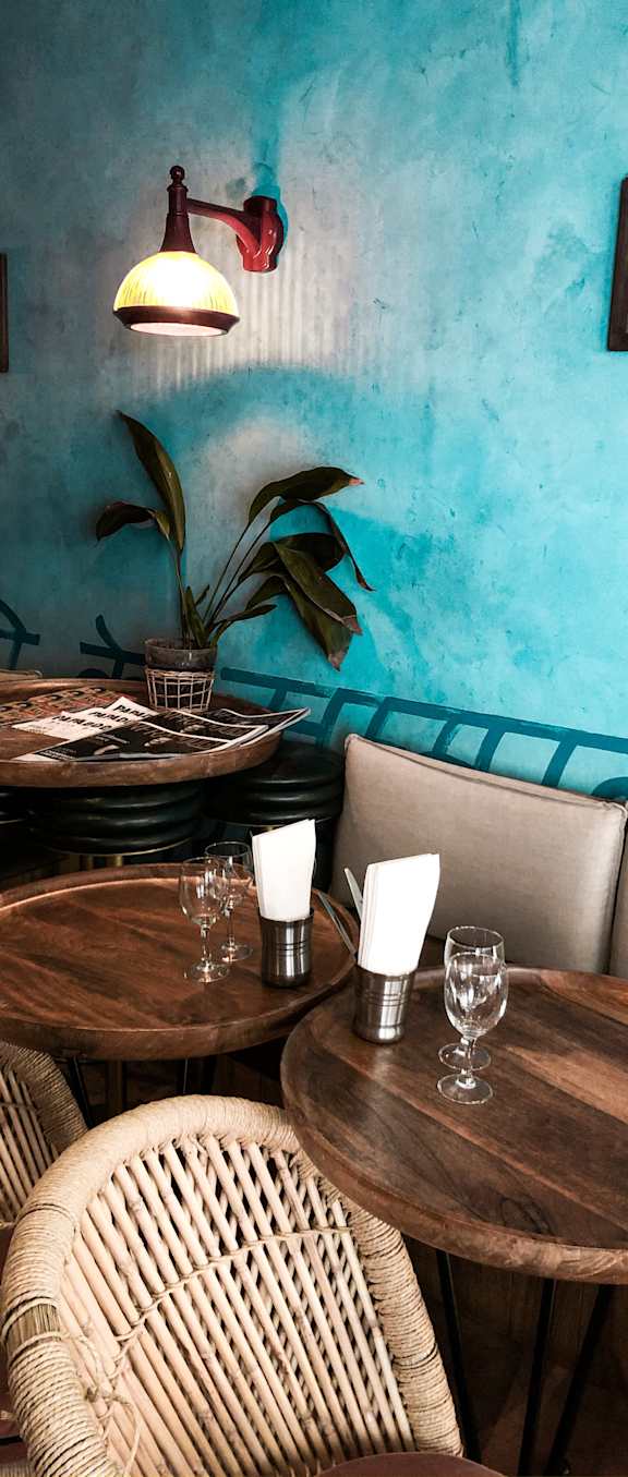 a room with blue walls and wooden tables and chairs