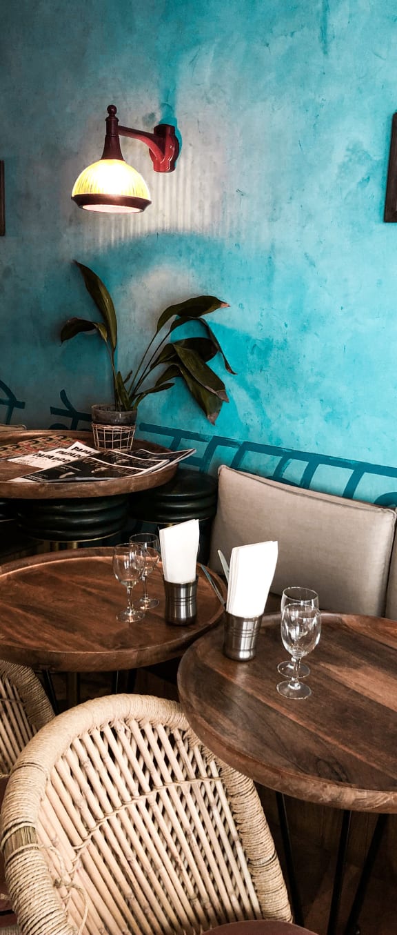 a room with blue walls and wooden tables and chairs