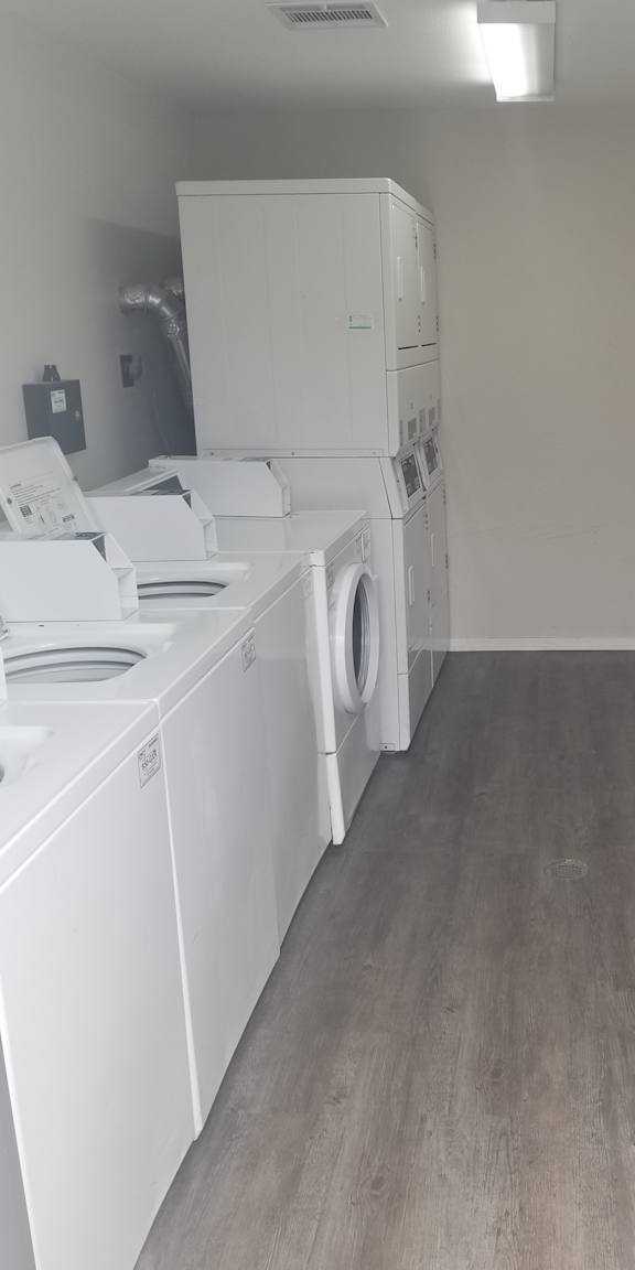A row of washing machines in a laundromat.