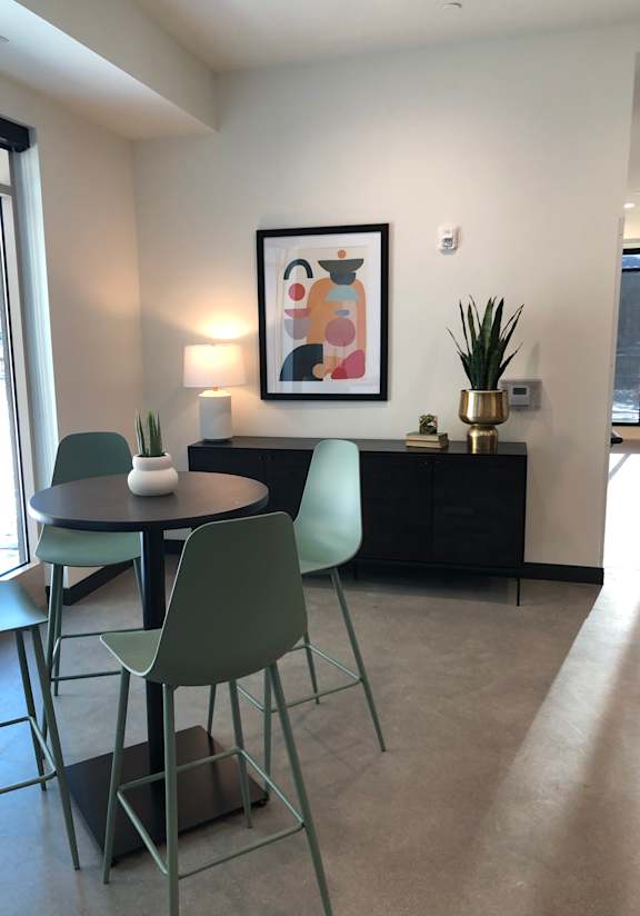 A chair with a green seat and back is in the foreground of the image.