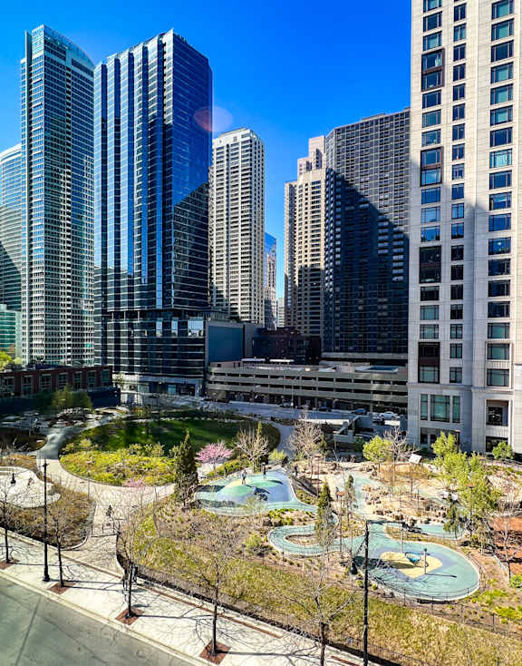 A cityscape with a pool in the foreground.