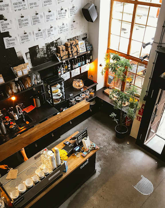 A coffee shop with a counter and a window.