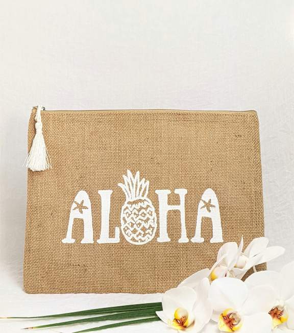 A burlap bag with the word "ALOHA" and a pineapple design is displayed.