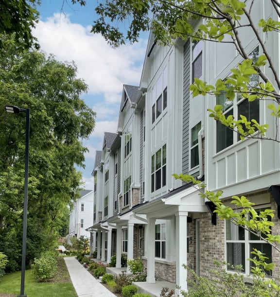 an exterior view of an enclave apartment building with a sign  at Enclave Crystal Lake Townhomes and Apartments, Crystal Lake, 60014