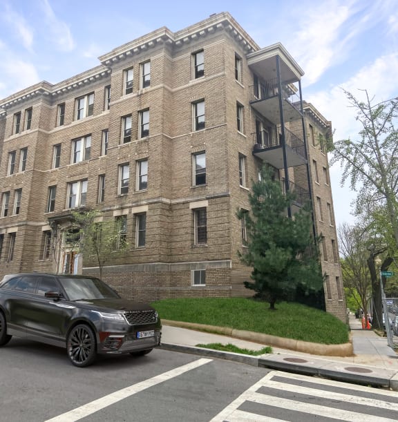 an apartment building with a car parked in front of it