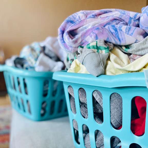 Two laundry baskets filled with clothes.
