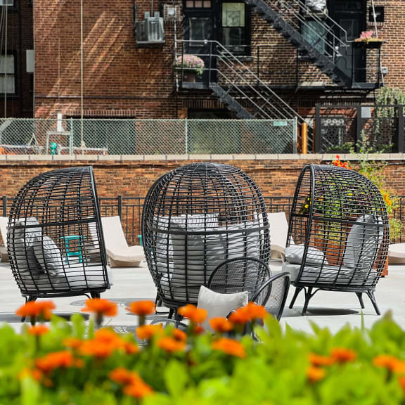 a group of chairs sitting next to each other on a sidewalk