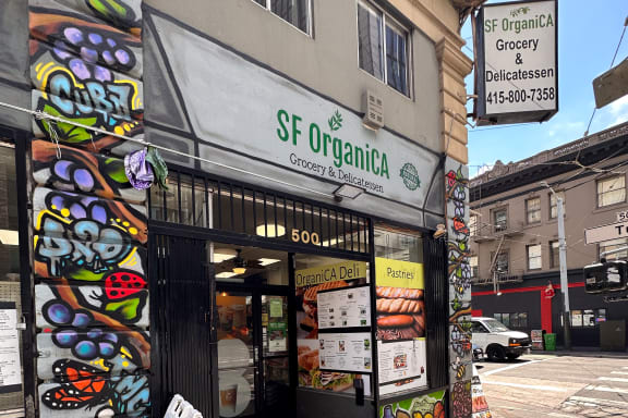 a sandwich shop with a sign in front of it