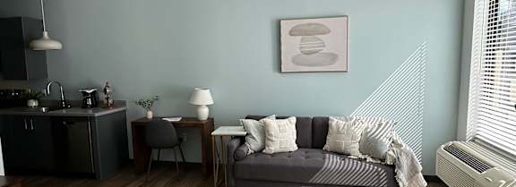 A living room with a grey sofa and a wooden coffee table.