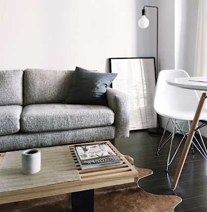a living room with a gray couch and a coffee table