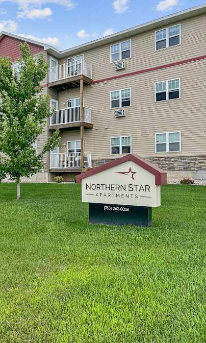 A building with a sign that says Northern Star Apartments in front of it.