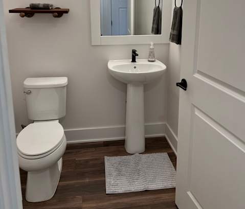 a small bathroom with a toilet and a mirror