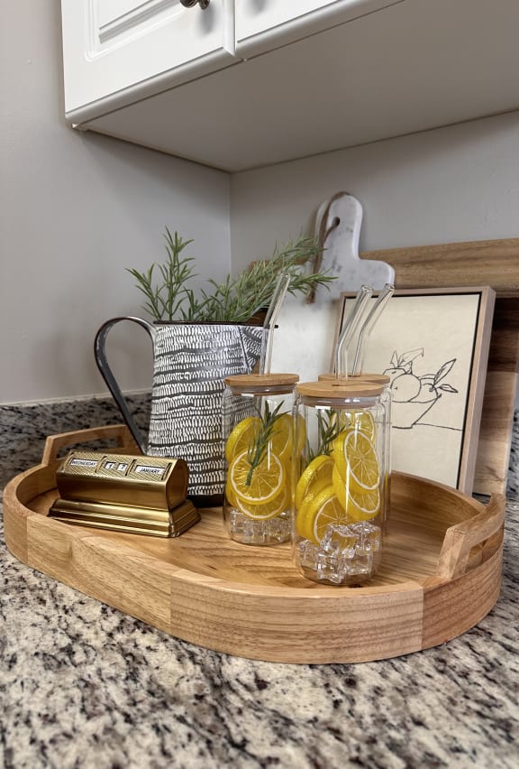 a wooden shelf with glasses on it on a kitchen counter at The Ledges Apartment Homes, Connecticut, 06340
