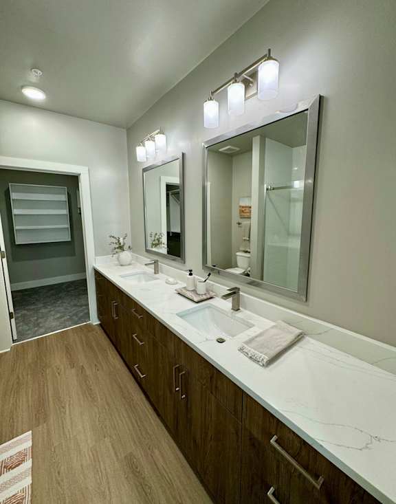 A bathroom with a white sink and a large mirror at The Collective Upper Westside Apartments, Atlanta, GA, 30318