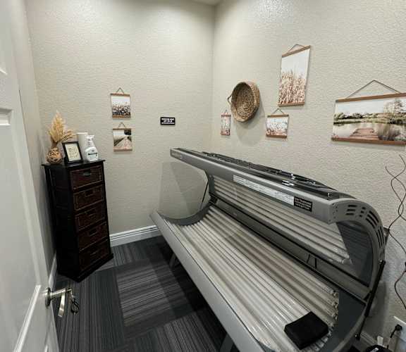 A white bathroom with a sink and a mirror.