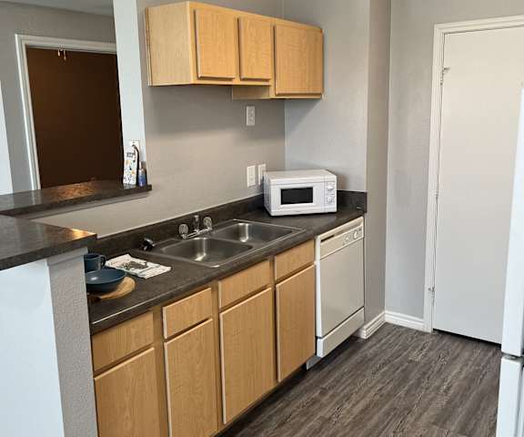 an empty kitchen with a sink and a microwave