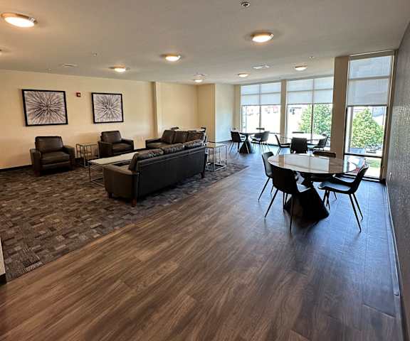 a living room and dining room with a table and chairs