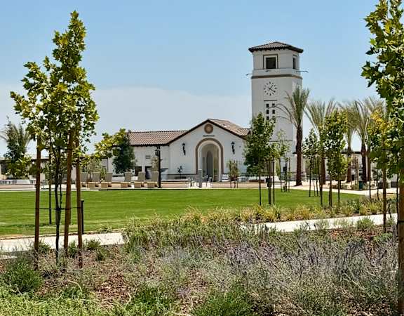 a church with a clock tower in a park