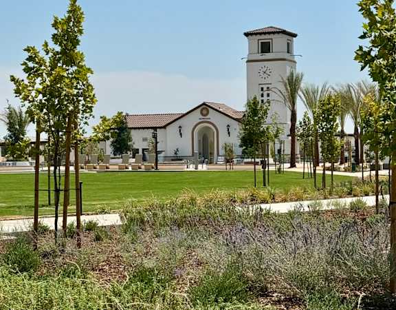 a church with a clock tower in a park