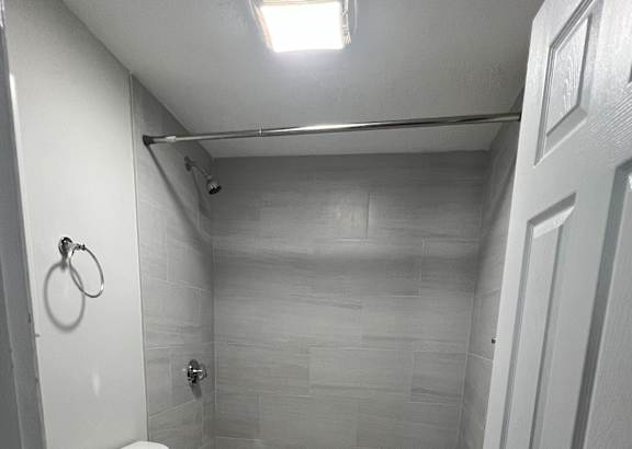 a small bathroom with a toilet and a bathtub