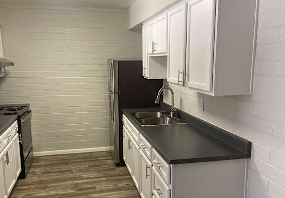 an overhead view of a kitchen with a stove and a microwave