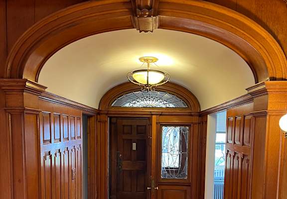 a view of a wood staircase from an oval window