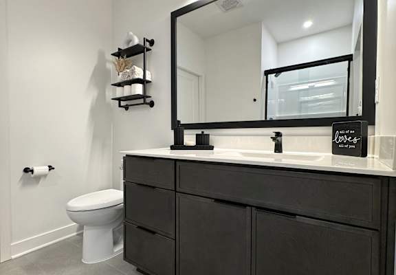 View of typical en-suite bathroom cabinetry & beautiful tile flooring