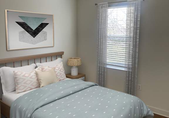 A bedroom with a bed covered in a blue comforter with white dots.
