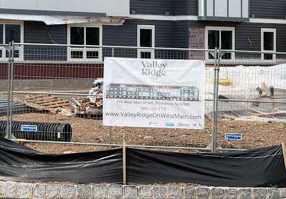 A construction site with a sign that reads "www.valerieKnapp.com".