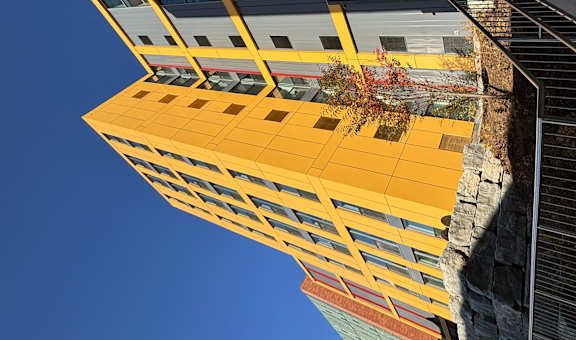 a view of the side of a building with stairs and a yellow facade