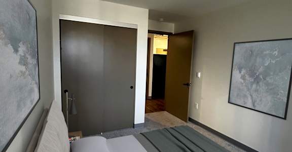 a bedroom with a bed and a door to a bathroom