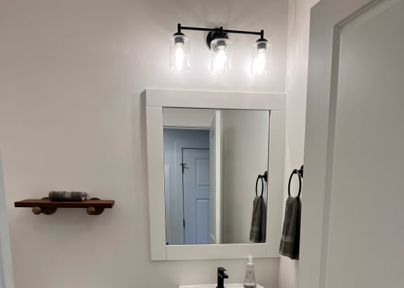 a small bathroom with a toilet and a mirror
