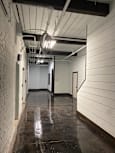 A room with a white ceiling and a concrete wall.